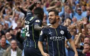 Manchester City midfielder Bernardo Silva, right, with defender Benjamin Mendy.