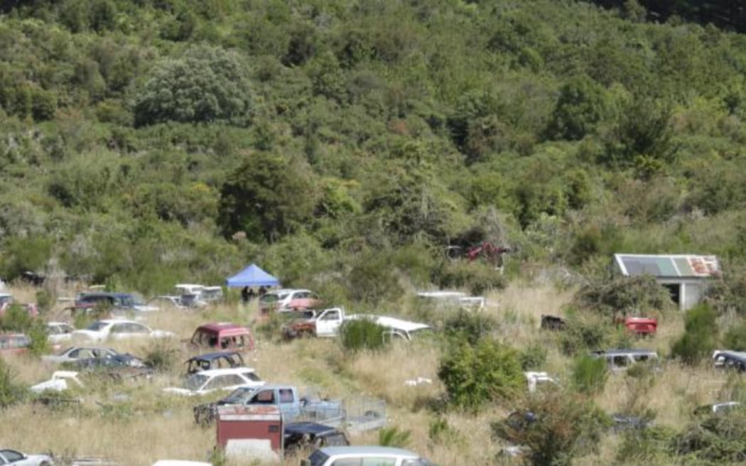 Police officers could be seen under a tent, while a digger worked nearby.