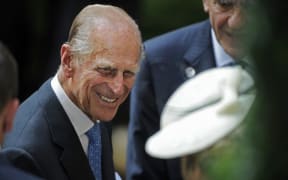 Prince Phillip, the Duke of Edinburgh, is greeted during his visit to the British Garden at Hanover Square in New York, Tuesday, July 6, 2010