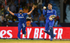 Afghanistan's Rahmanullah Gurbaz (R) celebrate his team's win of the ICC men's Twenty20 World Cup 2024 Super Eight cricket match between Afghanistan and Australia at Arnos Vale Stadium in Arnos Vale, Saint Vincent and the Grenadines on June 22, 2024. (Photo by Randy Brooks / AFP)