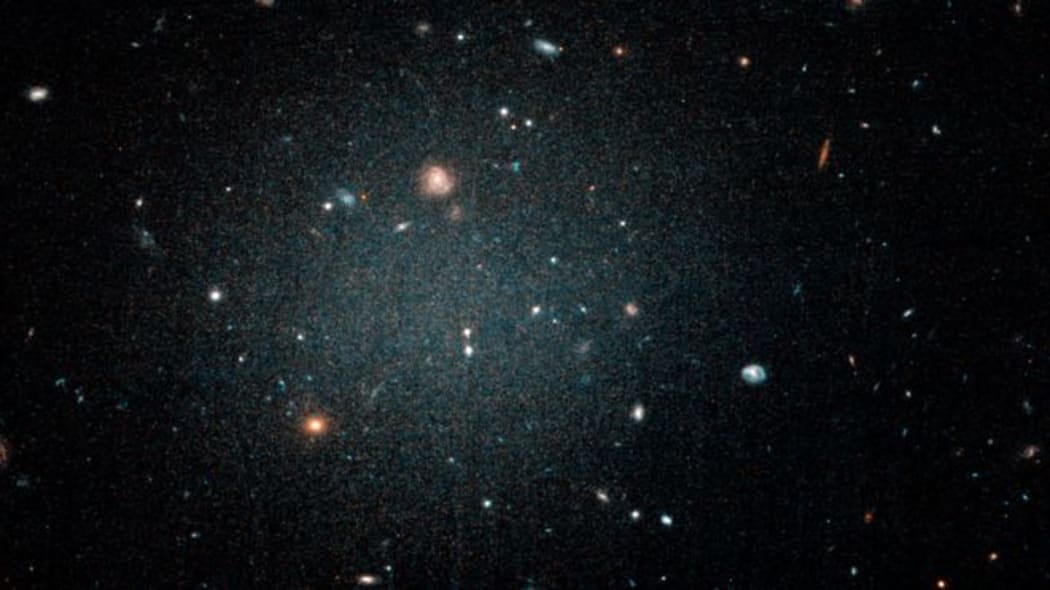 The NGC1052-DF2 galaxy is so thin other galaxies can be seen through it, as seen in this image from the Hubble telescope.
