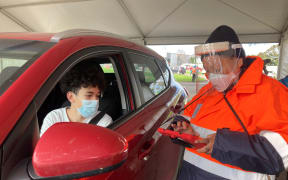Te Rangiura Royal with his mum Matire Harwood at Auckland's first drive-thru vaccination site.