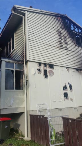 The damage from the suspected arson at a house at the centre of the Porirua siege.