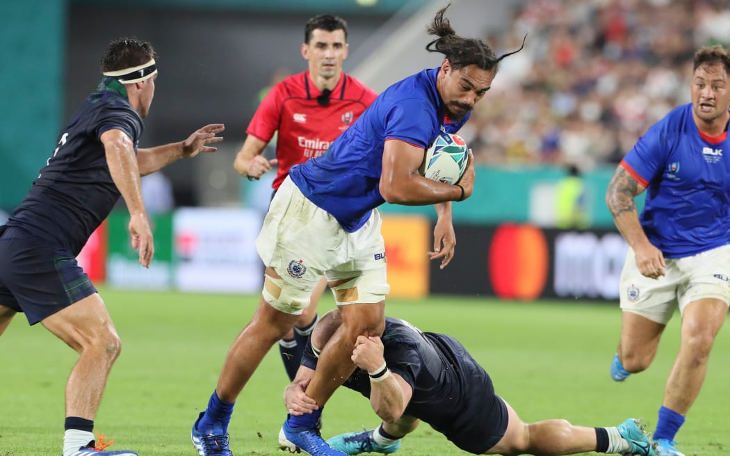 Samoa flanker Chris Vui tries to break Scotlish defence.