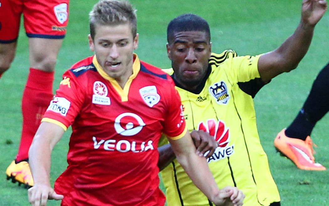 Phoenix' Roly Bonevacia battles for possession wih Adelaide United's Stefan Mauk.