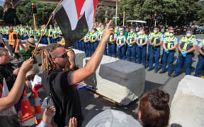 Protestors and Police standoff as police move concrete barricades