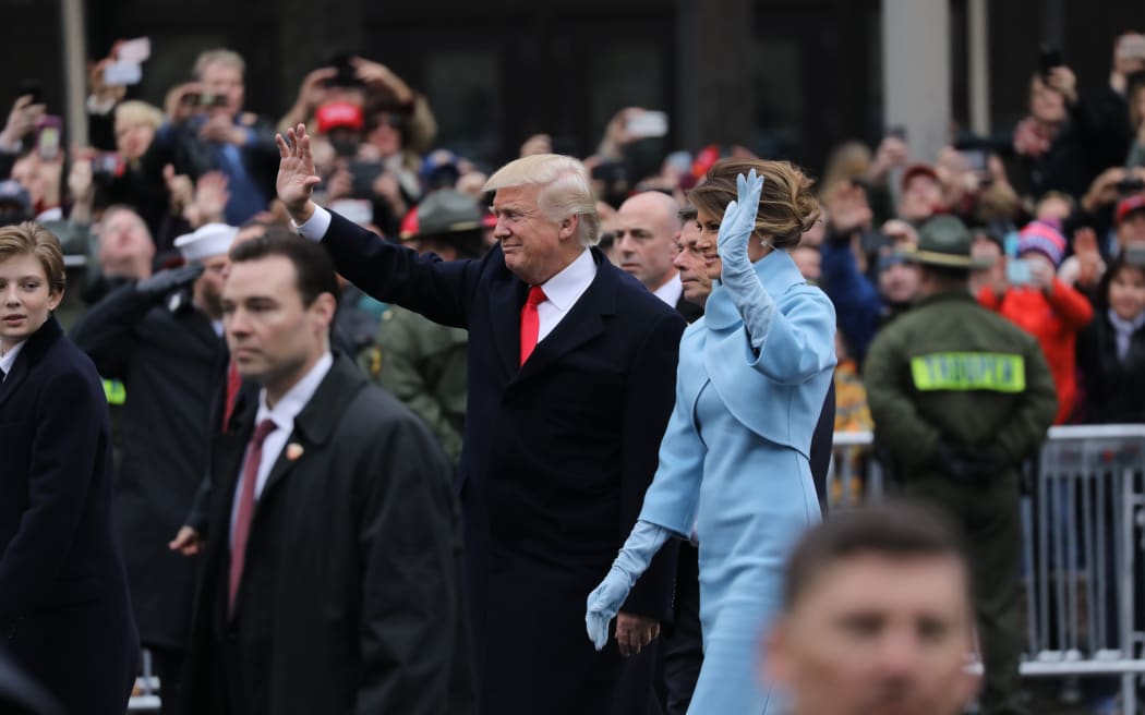 President Donald Trump and Melania Trump walking part of the way during the inaugural parade to the White House.