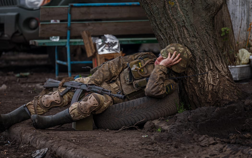 A Ukrainian serviceman takes a rest near the town of Bakhmut, in the Donetsk region on April 29, 2023.