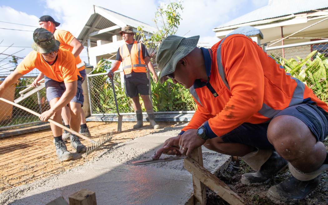 New Zealand and Tongan military personnel  work on buildings in Tonga that provide emergency accommodation.