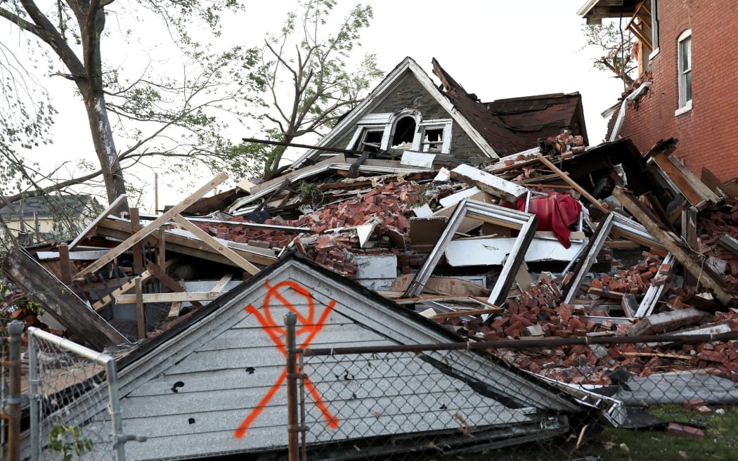 A house lies collapsed under a mountain of bricks, after a tornado struck in St. Louis, on Friday.