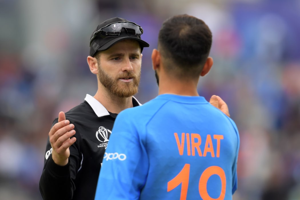 New Zealand's captain Kane Williamson (L) greets India's captain Virat Kohli at the end of play during the 2019 Cricket World Cup first semi-final between New Zealand and India at Old Trafford in Manchester, northwest England, on July 10, 2019.