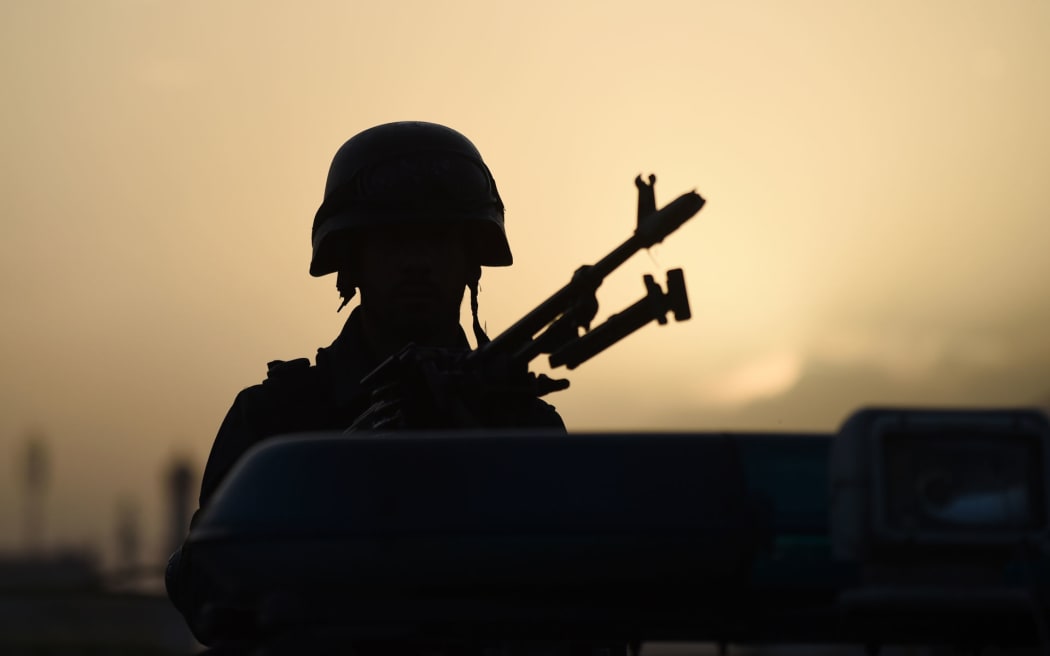 An Afghan security forces soldier stands guard near the site of a suicide bomb attack in Kabul on September 13. (file photo)
