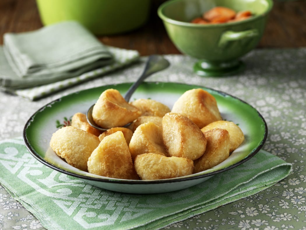 Roast potatoes in green vintage bowl (Photo by Diana Miller / Connect Images / Connect Images via AFP)