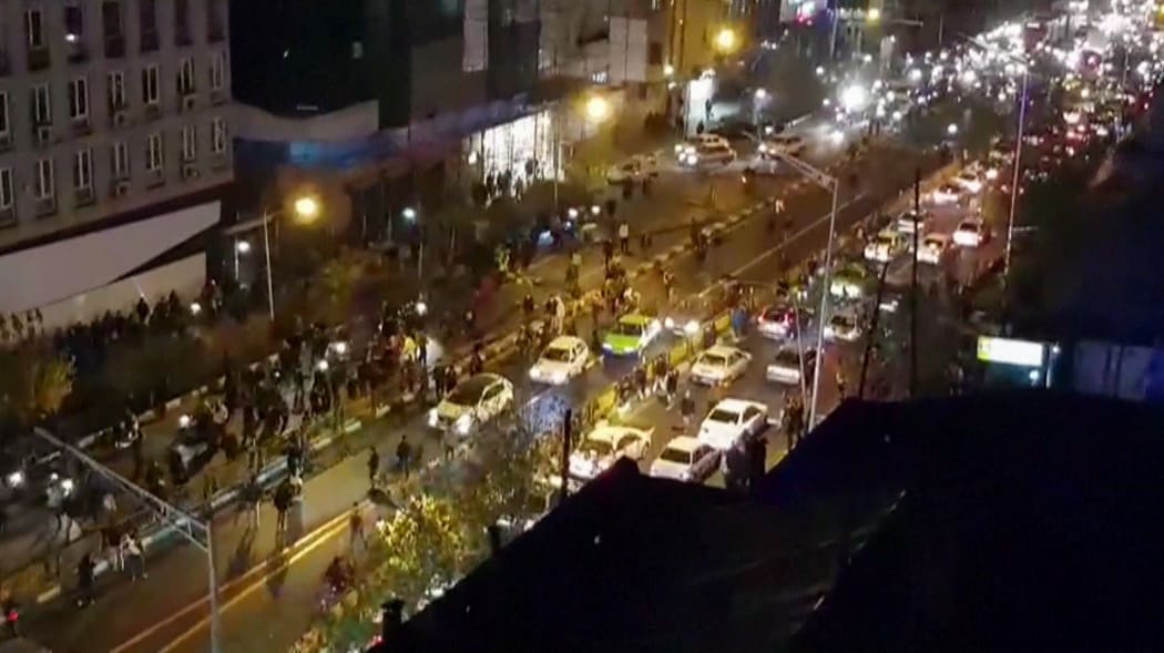 An image grab taken from a handout video released by Iran's Mehr News agency reportedly shows a group of men walking down a street in Tehran on Saturday.