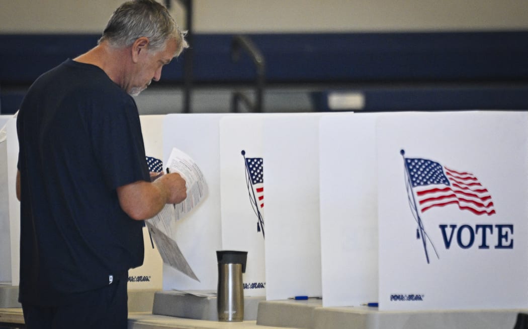 A person votes during early voting at a polling station in the first round of early voting at a polling place, October 21, 2024, in Daytona Beach, Florida. (Photo by Miguel J. Rodriguez Carrillo / AFP)
