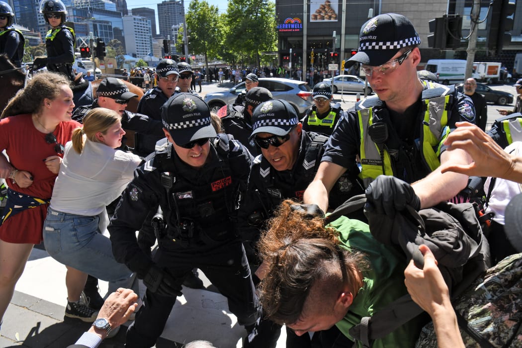 Police arrest a climate change protester outside the International Mining and Resources Conference (IMARC) being held in Melbourne on 29 October, 2019.