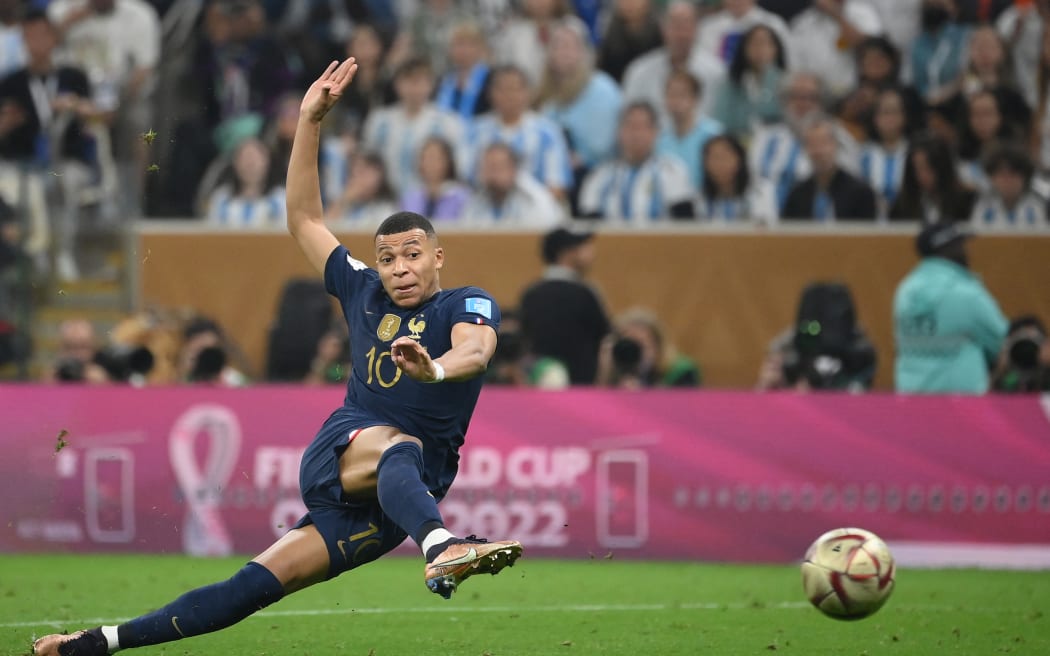 France's forward #10 Kylian Mbappe strikes the ball to score his team's second goal during the Qatar 2022 World Cup football final match between Argentina and France at Lusail Stadium in Lusail, north of Doha on December 18, 2022.