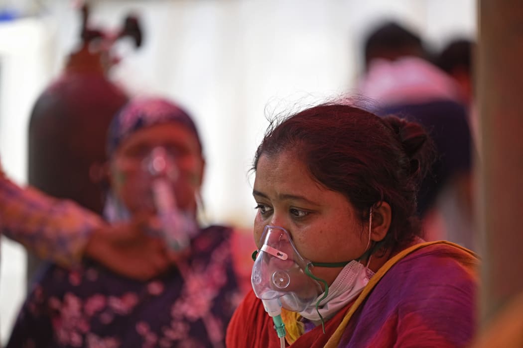 Patients breathe with the help of oxygen provided by a Gurdwara, a place of worship for Sikhs, under a tent installed along the roadside amid the Covid-19 pandemic in Ghaziabad on 26 April 2021.