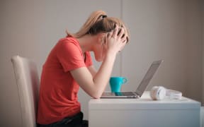 young blonde woman on laptop