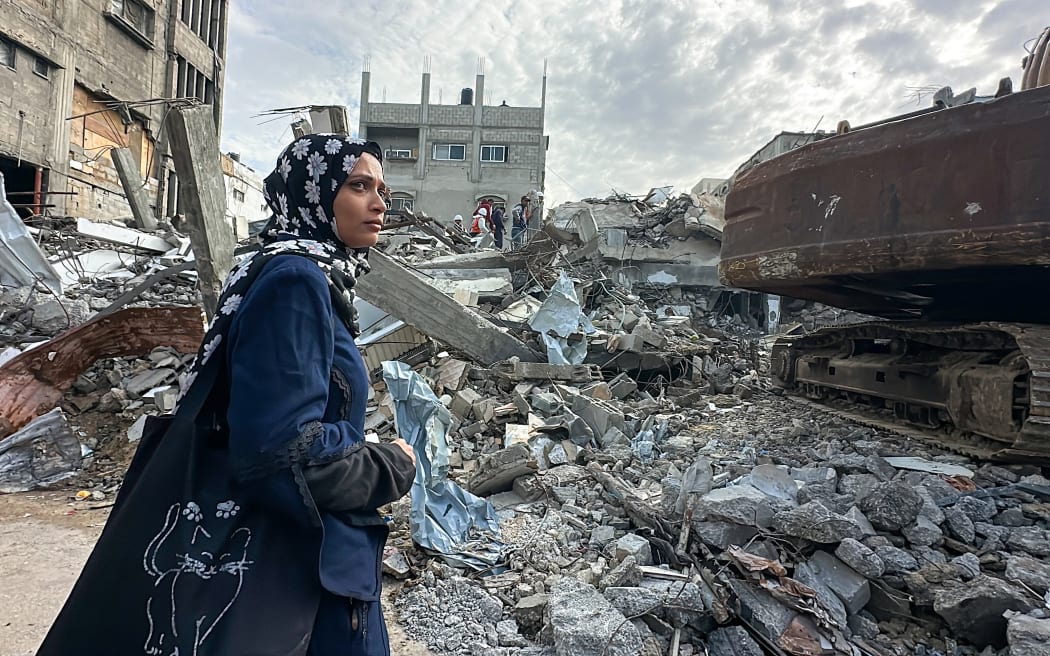 Residents watch a search operation in the Al-Amal neighborhood of Khan Yunis, Gaza Strip, on December 20, 2025. Civil defense teams are conducting search operations for the bodies of the Abu Hilal family in the Al-Amal neighborhood, months after they were killed on August 13, 2025. Search efforts have been hindered by a severe shortage of heavy equipment and access restrictions in the area. (Photo by Doaa Albaz / Middle East Images via AFP)