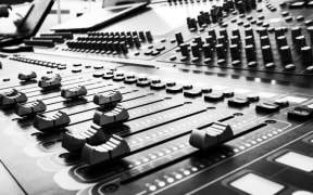 B and W sound desk (Photo by Adi Goldstein on Unsplash)