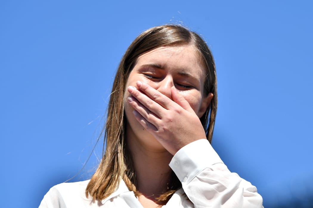 Former government staffer Brittany Higgins, who alleged publicly last month that she had been raped by a colleague in a minister's office in 2019, reacts as she speaks before protesters during a rally against sexual violence.