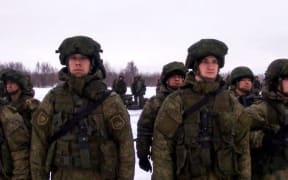 This handout image grab taken on January 6, 2022 and released on January 7, 2022 by the Russian Defence Ministry, shows Russian paratroopers boarding a military cargo plane to depart to Kazakhstan at the airport of Ivanovo.