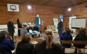 Buller mayor Jamie Cleine (standing, left) at a meeting of worried Inangahua Junction ratepayers this month.