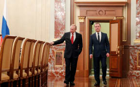 Russian President Vladimir Putin and Prime Minister Dmitry Medvedev walk before a meeting with members of the government in Moscow on January 15, 2020.