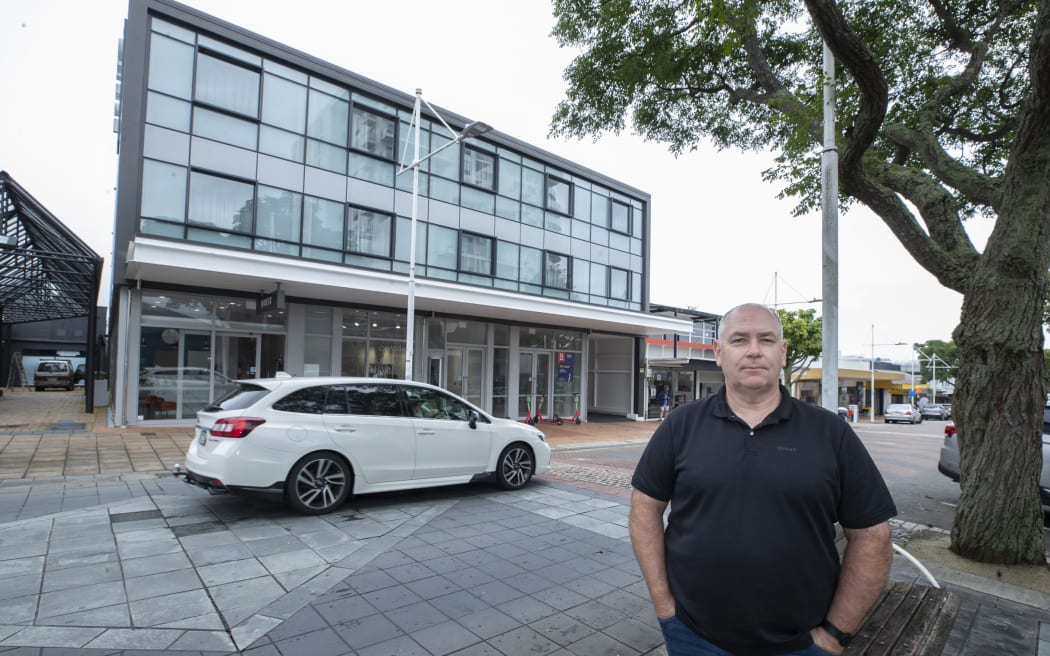 Craig Mckenzie stands outside a hotel in Tauranga.