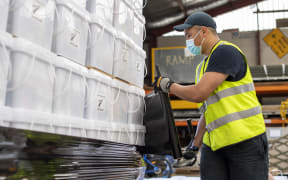 Air crew stack and secure pallets of disaster relief supplies to be sent to Tonga by Royal New Zealand Air Force, in the wake of a tsunami triggered by a volcanic eruption in January.