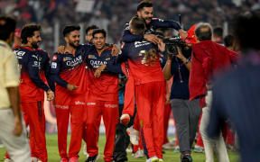 Royal Challengers Bengaluru's players celebrate with Virat Kohli (top) after winning the Indian Premier League (IPL) Twenty20 final cricket match between Royal Challengers Bengaluru and Punjab Kings at the Narendra Modi Stadium in Ahmedabad on June 3, 2025. (Photo by Arun SANKAR / AFP) / -- IMAGE RESTRICTED TO EDITORIAL USE - STRICTLY NO COMMERCIAL USE --