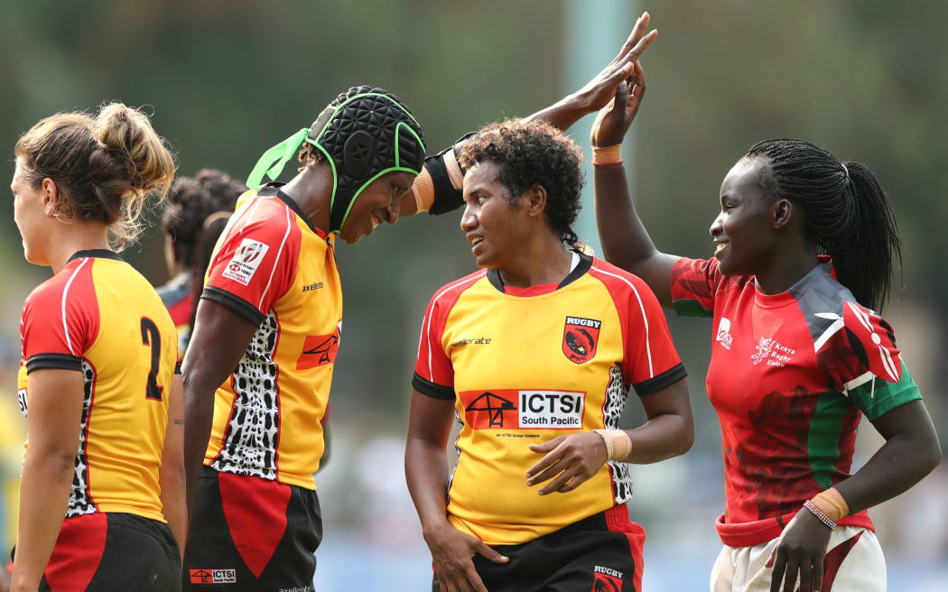 Papua New Guinea's Fatima Rama and Kenya's Grace Okulu high-five with each other after the game on day one of the World Rugby Women's Sevens Series Qualifier in Hong Kong on 4 April, 2019.