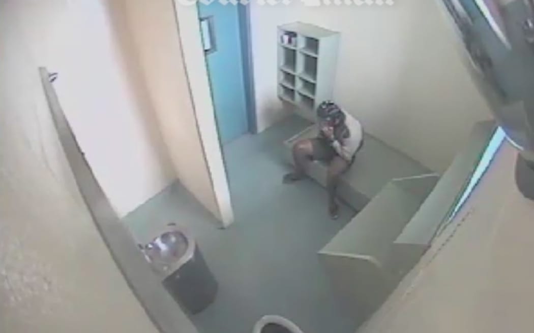 The images published by The Courier-Mail show the boy with a spit hood on his head and restrained with handcuffs.