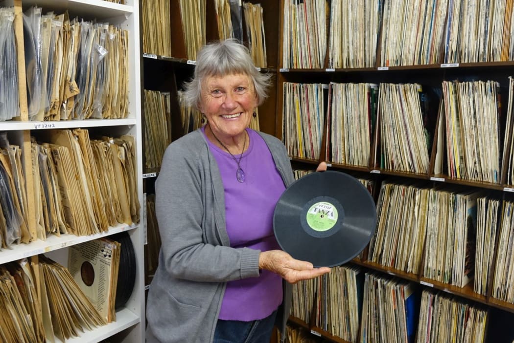 Village Radio librarian Cherry Feasey with New Zealand's first record, Blue Smoke