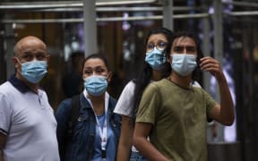 People wear a face masks in Midtown Manhattan in New York on July 29 2021.