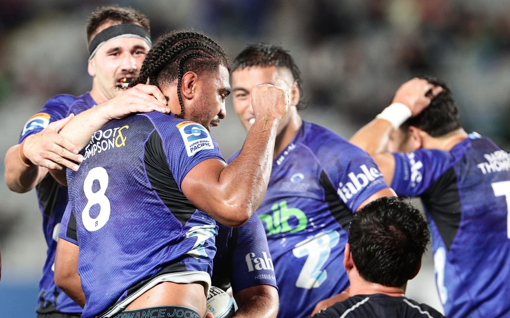 Hoskins Sotutu is congratulated after scoring during the round 9 Super Rugby Pacific match between the Blues and Brumbies at Eden Park.