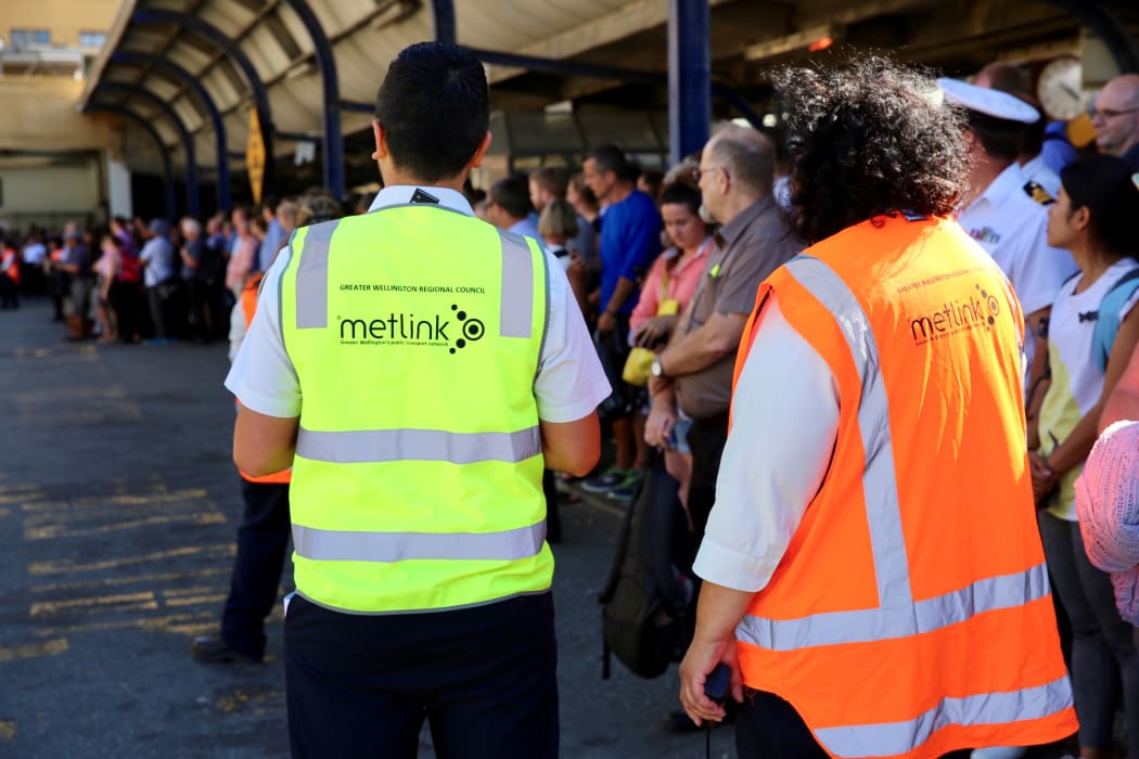 Commuters in Wellington wait for buses after a power outage cut most train services out of the region.