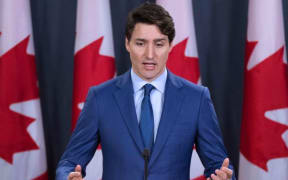 (FILES) In this file photo taken on March 07, 2019 Canadian Prime Minister Justin Trudeau speaks to the media at the national press gallery in Ottawa, Ontario. -