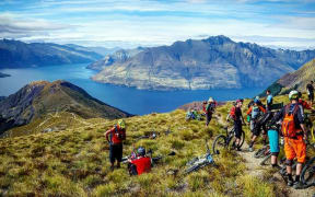 Mountain bikers above a lake in the South Islanding