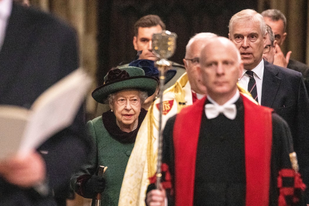 Prince Andrew walks alongside the Queen as they enter Westminster Abbey to attend the memorial service for Prince Philip.