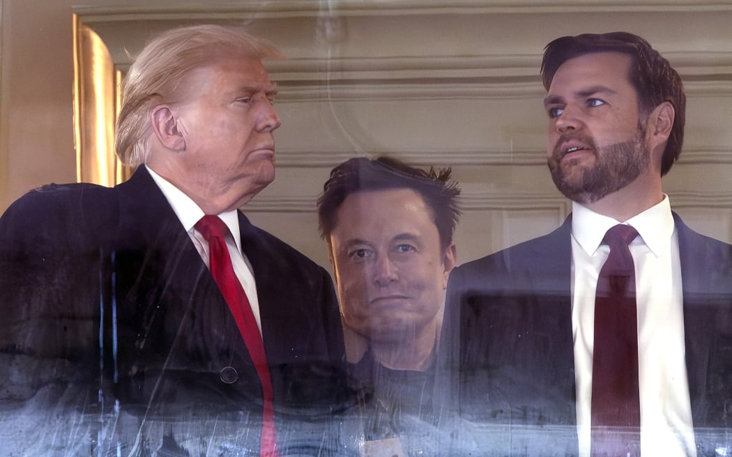 LANDOVER, MARYLAND - DECEMBER 14: (L-R) U.S. President-elect Donald Trump, Tesla CEO Elon Musk and Vice President-elect JD Vance attend the 125th Army-Navy football game at Northwest Stadium on December 14, 2024 in Landover, Maryland. Trump is attending the game with lawmakers and Cabinet nominees including, Vice President-elect JD Vance, Speaker of the House Mike Johnson (R-LA), Defense Secretary nominee Pete Hegseth, incoming Senate Majority Leader John Thune (R-SD) and others.   Kevin Dietsch/Getty Images/AFP (Photo by Kevin Dietsch / GETTY IMAGES NORTH AMERICA / Getty Images via AFP)