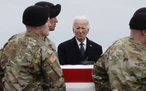 DOVER, DELAWARE - FEBRUARY 02: U.S. President Joe Biden places his hand over his heart as a U.S. Army carry team moves a flagged draped transfer case containing the remains of Army Sgt. Breonna Moffett during a dignified transfer at Dover Air Force Base on February 02, 2024 in Dover, Delaware. U.S. Army Sgt. William Rivers, Sgt. Breonna Moffett, Sgt. Kennedy Sanders were killed in addition to 40 other troops were injured during a drone strike in Jordan.   Kevin Dietsch/Getty Images/AFP (Photo by Kevin Dietsch / GETTY IMAGES NORTH AMERICA / Getty Images via AFP)