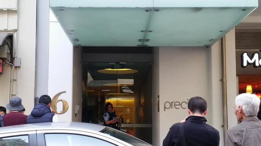 Police guard the apartment building in central Auckland during today's callout.
