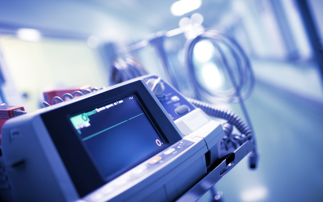 Straight line with no ECG waves on the monitor in the hospital department, concept of patient clinical death.