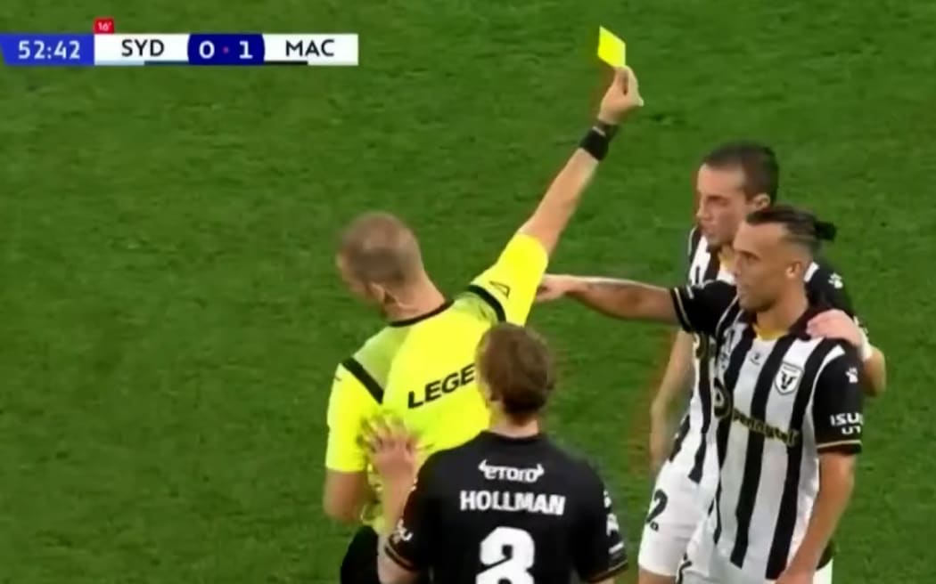 Clayton Lewis gets a yellow card in a A League game against Sydney FC, December 2023.