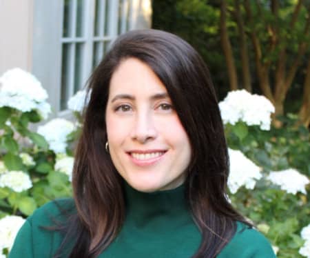 Allison Sweet Grant with shoulder-length dark brown hair, smiling.