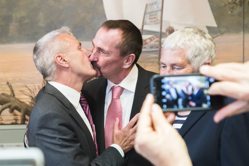 Bodo Mende (C-L) and Karl Kreile (C-R) kiss after their wedding ceremony in Schoeneberg town hall in Berlin, Germany on October 1, 2017.