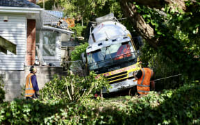 A person is dead after a concrete mixer flipped into a house in Auckland's Remuera, July 2025