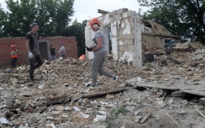 BOROMLIA, UKRAINE - JUNE 17, 2022 - Volunteers help rescuers clear away the rubble at buildings destroyed by Russian invaders, Boromlia village, Sumy Region, northeastern Ukraine. This photo cannot be distributed in the Russian Federation. NO USE RUSSIA. NO USE BELARUS. (Photo by Pavlo_Bagmut / NurPhoto via AFP)